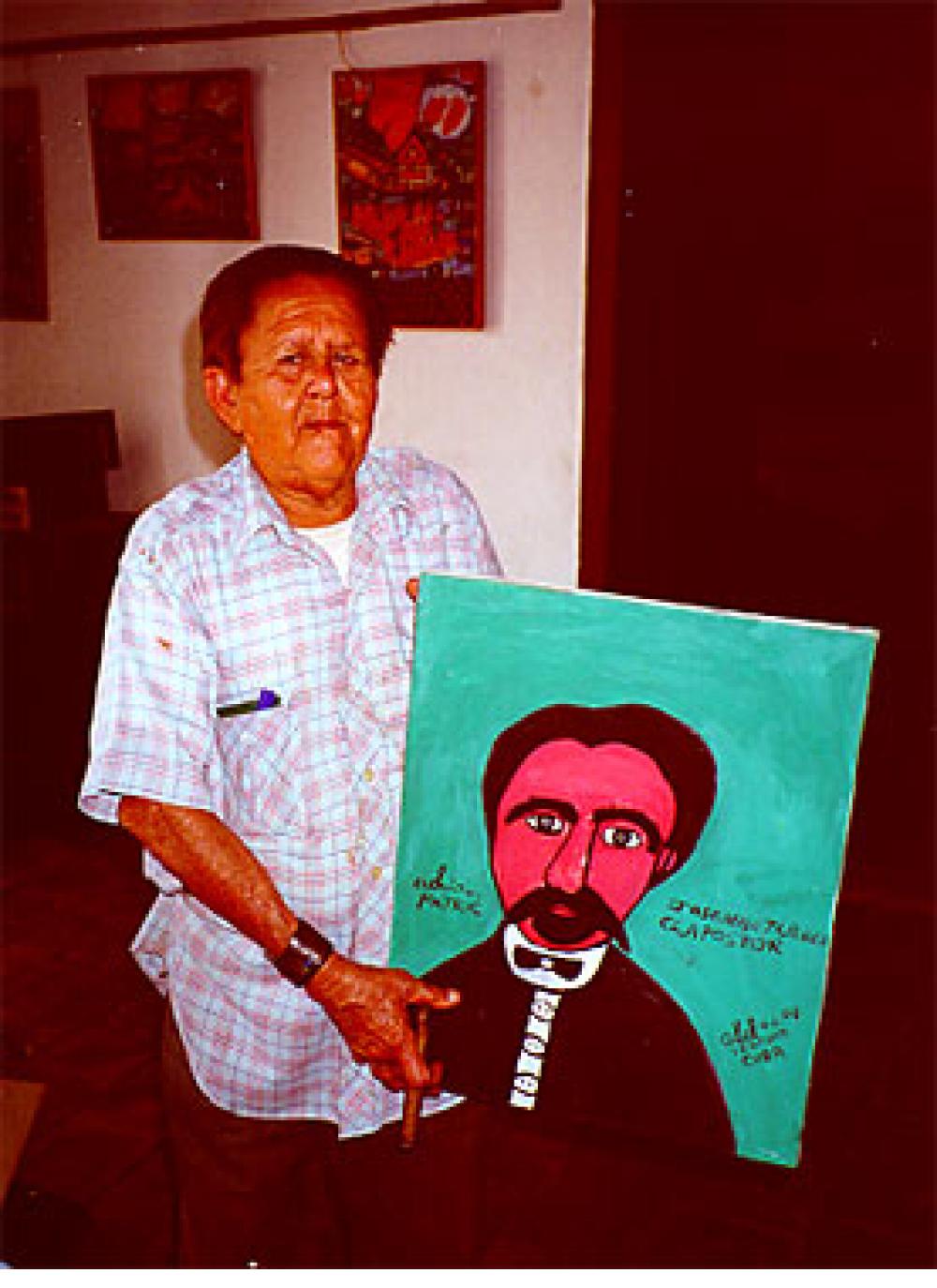 Abel Perez Mainegra with cigar and painting of Jose Marti. Trinidad, Cuba, 2000.