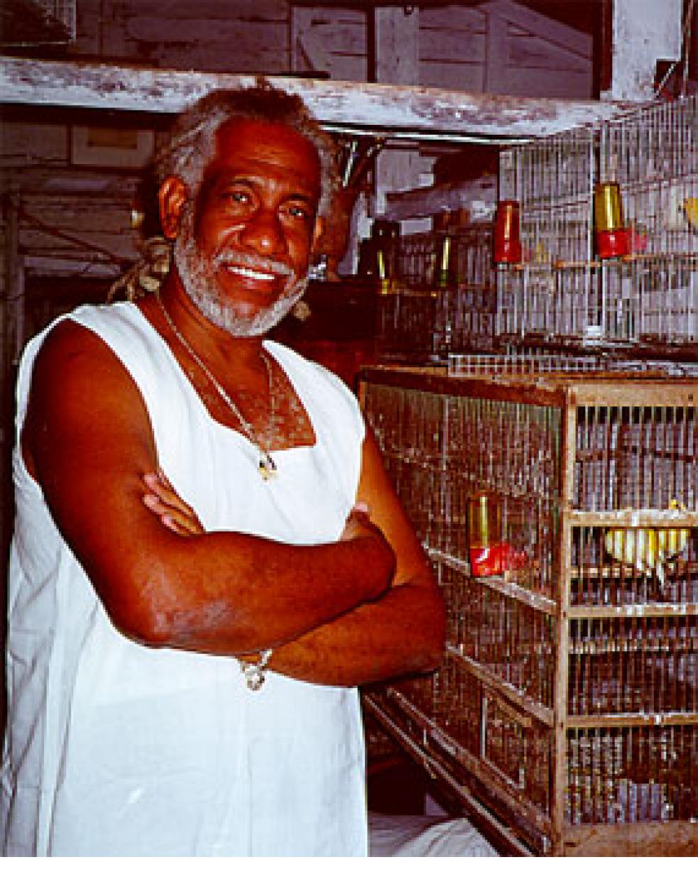 Painter Manuel Mendive in his studio with some of his birds.