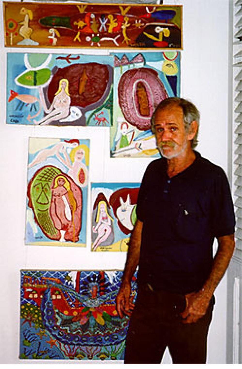 Wayacon (Julian Espinosa) with some of his paintings. Cienfuegos, Cuba, 2000.