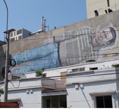 This man was stretched out on a second floor wall in downtown Lima.