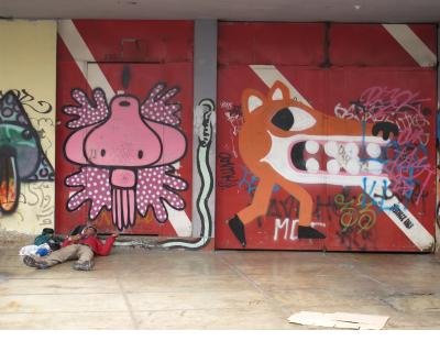Two graphic styles of street art and a street person in Barranco. Two graphic styles of street art and a street person in Barranco.