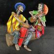 Two Musicians on a Log - calavera sculpture