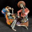 Two Musicians on a Log - calavera sculpture