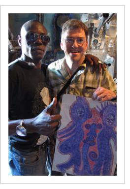 Guyodo with tourist and '"Marassa" drawing. (Photograph © Anthony Hart Fisher 2014).