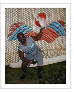 Papier Maché artist Tidier Levoyant from Jacmel, Haiti (with parrot mask #hmsk-09), at the Smithsonian Folklife Festival in Washington DC, July, 2004 ( Photograph © Anthony Hart Fisher 2004).