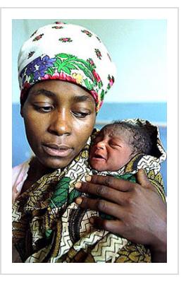 Sophia Tedro proudly displays her newborn baby Rositha in the Shibuto hospital 200 kms north of the capital Maputo. Sophia and her baby made headlines after she gave birth to Rositha while she was trapped in a tree and both were rescued by helicopter. Courtesy of Guardian UK, March, 2000. Photo: AP