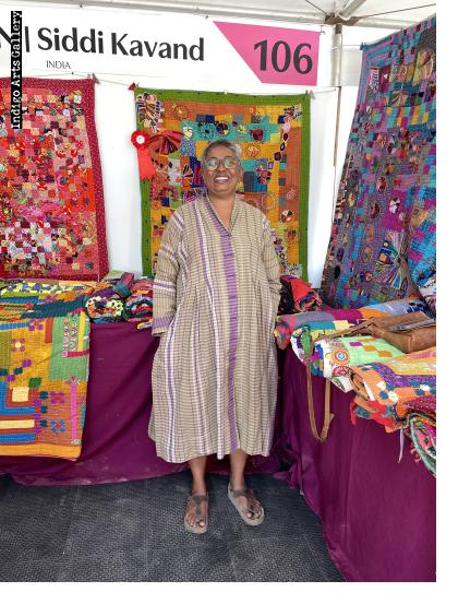 Anitha N Reddy with award-winning quilt at 2025 International Folk Art Market
