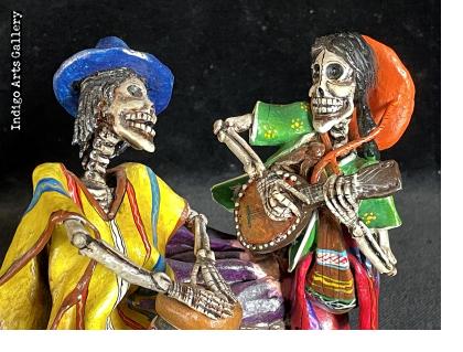 Two Musicians on a Log - calavera sculpture