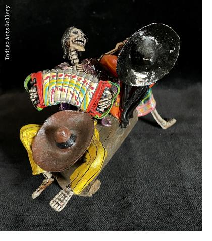 Two Musicians on a Log - calavera sculpture
