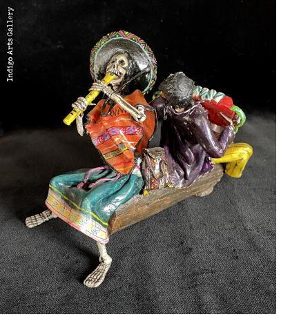 Two Musicians on a Log - calavera sculpture