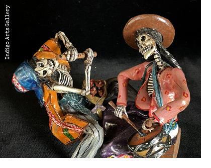 Two Musicians on a Log - calavera sculpture